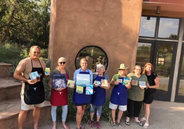 seven people displaying their completed art work