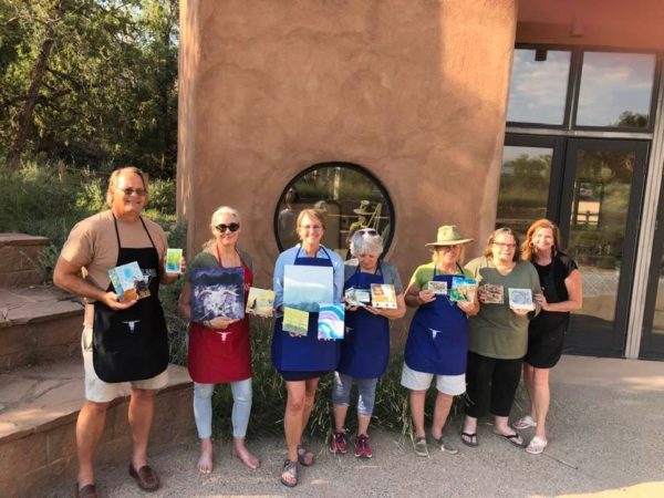 image of seven people holding their completed art work