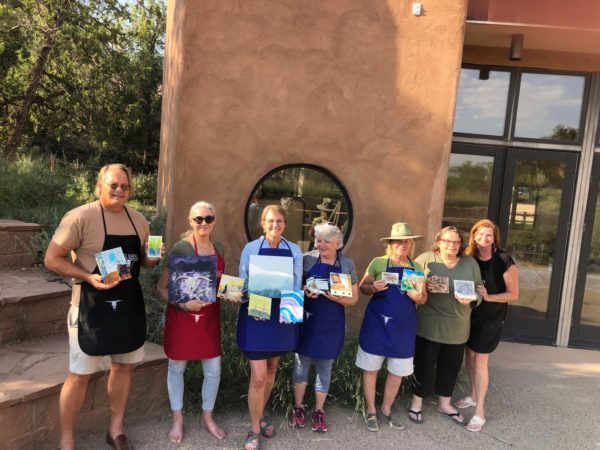 seven people displaying their completed art work
